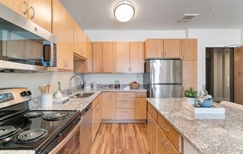 Granite Counter Tops In Kitchen at Harbor at Twin Lakes 55+ Apartments, Roseville, Minnesota